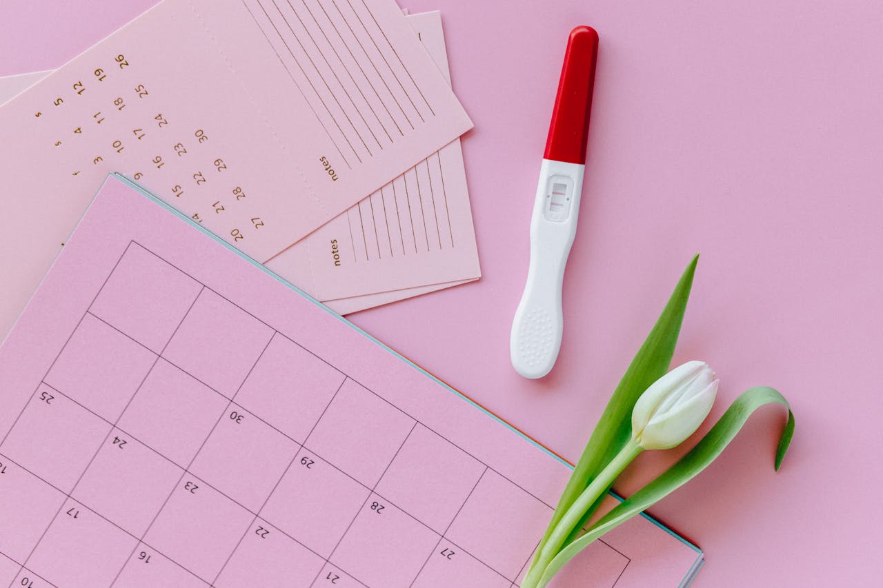 White and Red Pregnancy Test with Calendar